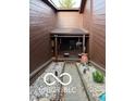 Private front courtyard with decorative gravel, stone pavers, and a covered porch at 209 Brighton Ct, Greenwood, IN 46143