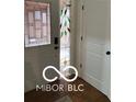 Entryway with decorative stained glass sidelight window and hardwood flooring at 209 Brighton Ct, Greenwood, IN 46143