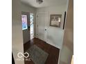 Inviting foyer with hardwood floors, a decorative front door and lovely rug at 209 Brighton Ct, Greenwood, IN 46143
