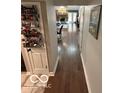 Hallway view showcasing hardwood floors, neutral walls and view of the living room at 209 Brighton Ct, Greenwood, IN 46143