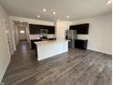 Open-concept kitchen with a center island, stainless steel appliances, and sleek cabinetry at 2143 Warbler St, Danville, IN 46122