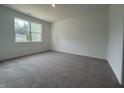 Bedroom featuring neutral paint, carpeted floors, and a large window allowing natural light at 2159 Warbler St, Danville, IN 46122