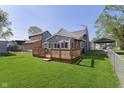 A spacious backyard features a wooden deck and a metal chainlink fence around the property at 2319 S I St, Elwood, IN 46036