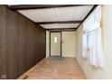 The entryway features a wood paneled wall and a door with a window for natural light at 2319 S I St, Elwood, IN 46036
