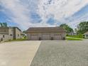 Detached three-bay garage with concrete and gravel parking pads, located on a spacious lot at 238 Jefferson St, Pendleton, IN 46064