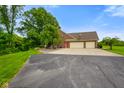 Spacious home showcasing a large attached garage and a long, private driveway at 2508 Indian Creek Rd, Trafalgar, IN 46181