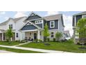 Inviting two-story home showcasing blue siding and stone details in a suburban setting at 2542 Barstow Dr, Whitestown, IN 46075