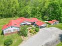 Expansive aerial view showcases the home's red roof, landscaping, covered parking, and ample yard space at 295 Maple Turn Rd, Martinsville, IN 46151