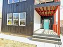 Modern front porch with a striking blue door, steps, and contemporary design at 337 N Beville Ave, Indianapolis, IN 46201