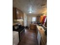 Functional kitchen featuring wood cabinets, gas range, and white appliances at 3731 N Tacoma Ave, Indianapolis, IN 46218
