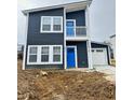 Charming two-story home with blue front doors, white trim, attached garage, and unfinished lawn at 3811 N Lawndale Ave, Indianapolis, IN 46254