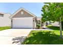 Inviting single-Gathering home with a two-car garage and a neatly landscaped front yard at 4033 Tahoe Dr, Indianapolis, IN 46235