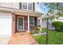 Inviting entrance with brick accents, a charming flower garden, and a decorative address post, creating a warm welcome at 4316 Village Trace Dr, Indianapolis, IN 46254