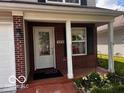 Charming front porch with red brick and decorative touches creates an inviting entry at 4316 Village Trace Dr, Indianapolis, IN 46254
