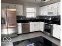 Well-equipped kitchen with stainless steel appliances, granite countertops, and tiled backsplash at 4316 Village Trace Dr, Indianapolis, IN 46254