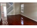 Spacious living room featuring gleaming hardwood floors and plenty of natural light at 4316 Village Trace Dr, Indianapolis, IN 46254
