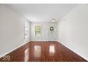 Spacious living room with gleaming hardwood floors, bathed in natural light from multiple windows at 4316 Village Trace Dr, Indianapolis, IN 46254