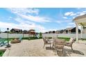 Open backyard with patio seating, fire pit, playground and fenced-in lawn at 4763 W Tradwell Dr, New Palestine, IN 46163