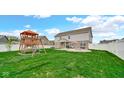 Large backyard featuring a playset, covered patio, and fire pit area for Gathering fun at 4763 W Tradwell Dr, New Palestine, IN 46163