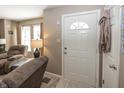 Warm entryway featuring a white front door with decorative window, leading into the carpeted living area at 540 Hanley St, Plainfield, IN 46168