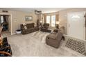 Spacious living room with plush carpeting, ceiling fan, and comfortable brown reclining furniture at 540 Hanley St, Plainfield, IN 46168