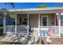 Inviting covered porch with white railing, patriotic decorations, and a welcoming 'Just Be Kind' sign at 540 Hanley St, Plainfield, IN 46168