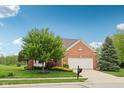 Charming brick home with a two-car garage and well-manicured lawn, enhancing curb appeal at 542 Hadleigh Ct, Westfield, IN 46074