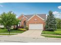 Charming brick home with a two-car garage and well-manicured lawn, enhancing curb appeal at 542 Hadleigh Ct, Westfield, IN 46074