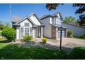 Street view of a charming two-story home with landscaped front yard and two-car garage at 5622 Mead Ct, Indianapolis, IN 46220