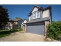 Close-up of a two-story home with a two-car garage and well-kept landscaping at 5622 Mead Ct, Indianapolis, IN 46220