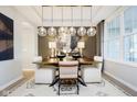 Modern dining room with stylish lighting, neutral decor, and comfortable seating for six at 583 Dalton Way, Avon, IN 46123
