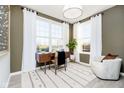 Cozy home office featuring large windows, modern desk and comfortable accent chair at 583 Dalton Way, Avon, IN 46123