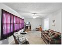 Cozy living room featuring a plaid sofa, armchair, and entertainment center at 633 Park Dr, Greenwood, IN 46143