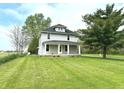 Inviting two-story home with a covered front porch and a lush green lawn at 660 N 700 E, Whitestown, IN 46075