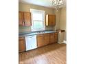Functional kitchen featuring wood cabinets, a double basin sink, and a white dishwasher at 660 N 700 E, Whitestown, IN 46075