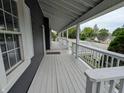 Inviting front porch with white railing, gray floorboards and an excellent view at 689 N Main St, Martinsville, IN 46151