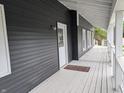 Inviting front porch with white railing, gray floorboards and an excellent view at 689 N Main St, Martinsville, IN 46151
