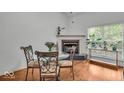 Bright dining area with a fireplace, large windows, hardwood floors and stylish table set at 6916 Ralph Ct, Indianapolis, IN 46220