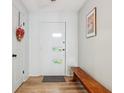 Bright foyer featuring a decorative front door, wood floors, and stylish decor at 7277 N College Ave, Indianapolis, IN 46240