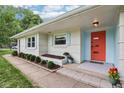 Charming exterior with orange door and manicured landscaping at 7277 N College Ave, Indianapolis, IN 46240