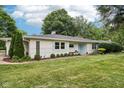 Charming one-story home with a well-manicured lawn and landscaping at 7277 N College Ave, Indianapolis, IN 46240