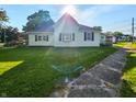 Sunlit home showcasing lush lawn, complemented by a clear blue sky at 734 W North St, Lebanon, IN 46052