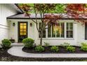 Close-up of the entrance and surrounding landscaping of a charming home at 7531 Mohawk Ln, Indianapolis, IN 46260
