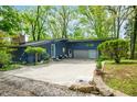 Charming blue home with a spacious driveway, lush landscaping, and a welcoming entrance at 7753 Ivy Dr, Nineveh, IN 46164