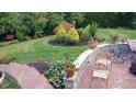 Landscaped backyard with a beautiful brick patio, garden wall and well-maintained lawn at 8065 Bayberry Ct, Indianapolis, IN 46250