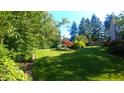 Lush backyard featuring a well-manicured lawn, mature trees and manicured landscaping at 8065 Bayberry Ct, Indianapolis, IN 46250