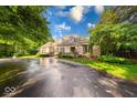 Attractive single-story home with meticulous landscaping, mature trees, and a wide driveway at 8065 Bayberry Ct, Indianapolis, IN 46250