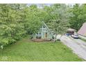 A-frame home with a well-maintained lawn, surrounded by trees and detached garage on a picturesque lot at 809 Iron Bridge Rd, Cicero, IN 46034