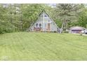 A-frame home with a well-manicured lawn and mature trees offering a serene, private setting at 809 Iron Bridge Rd, Cicero, IN 46034