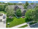 An aerial view of the lovely brick home and nicely manicured lawn at 10155 Landis Blvd, Fortville, IN 46040